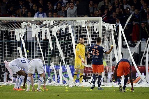 Auxerre's supporters throw tennis balls and toilet paper on the pitch